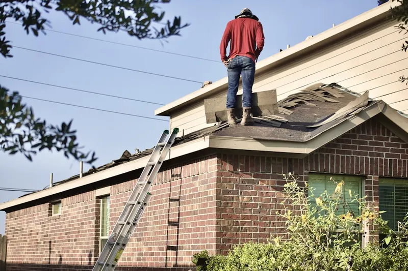 Professional roofer working on a residential roof in Owings Mills